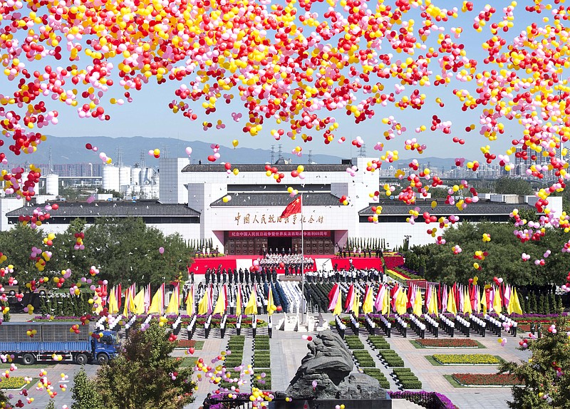 
              In this photo released by China's Xinhua news agency, balloons are released into the air during a ceremony to mark the 69th anniversary of China's victory over Japan at the Museum of the War of Chinese People's Resistance Against Japanese Aggression, in Beijing Wednesday, Sept. 3, 2014. China commemorated Japan’s World War II surrender as part of Beijing’s campaign to remind the world of Tokyo’s historical aggression amid worsening relations between the two countries. (AP Photo/Xinhua, Wang Ye) NO SALES
            