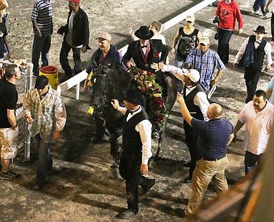 Casey Wright and I Am Jose´ accept congratulations as they leave the ring after winning the Tennessee Walking Horse World Grand Championship on Aug. 31 in Shelbyville, Tenn., for the second consecutive year.