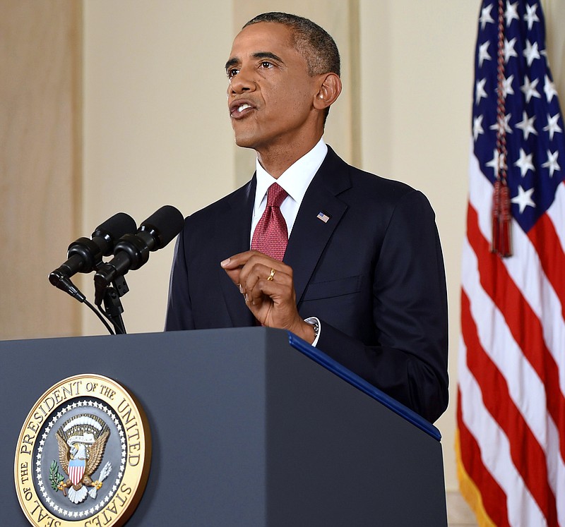 
              President Barack Obama addresses the nation from the Cross Hall in the White House in Washington, Wednesday, Sept. 10, 2014. In a major reversal, Obama ordered the United States into a broad military campaign to “degrade and ultimately destroy” militants in two volatile Middle East nations, authorizing airstrikes inside Syria for the first time, as well as an expansion of strikes in Iraq.  (AP Photo/Saul Loeb, Pool)
            