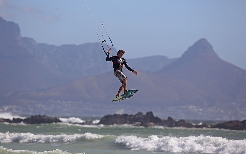 
              FILE -  In this Sunday, Feb. 2, 2014 file photo a kite surfer surfs against the backdrop of Table Mountain in Cape Town South Africa, the top city destination in the country. Tour operators across Africa say they face difficulties as the Ebola outbreak, which has killed more than 2,200 people in four countries, continues to defy international efforts to control it. Tourism, a major source of revenue for many African countries, especially Kenya and South Africa, is increasingly being hurt as some potential visitors hesitate over visiting the continent which is home to the disease. (AP Photo/Schalk van Zuydam, File)
            