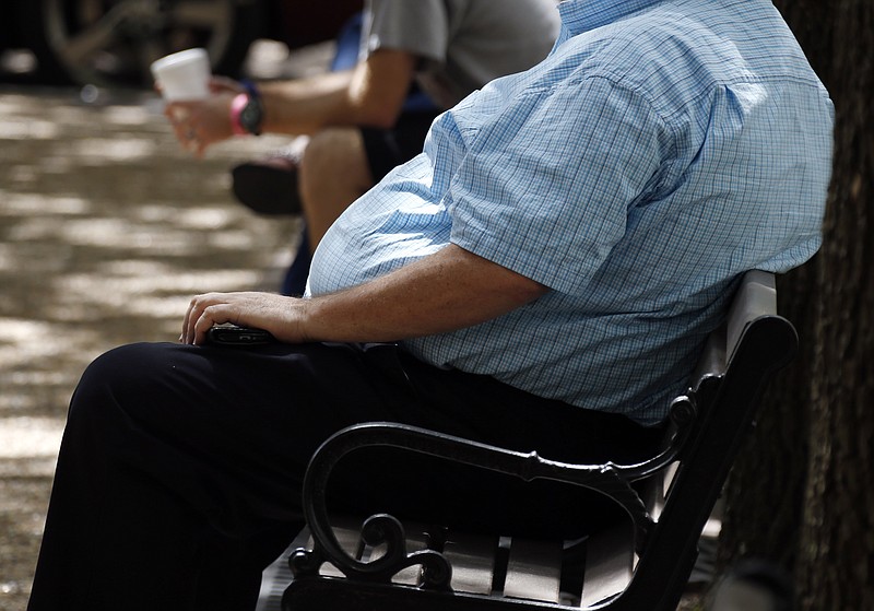 
              FILE - In this Thursday, Sept. 4, 2014, file photo, an overweight man rests on a bench in Jackson, Miss. Rising numbers of American adults have the most dangerous kind of obesity, belly fat, despite evidence that overall obesity rates may have plateaued, government data shows. Abdominal obesity affects 54 percent of U.S. adults, versus 46 percent in 1999-2000, and the average waist size crept up an inch, too, according to the most recent statistics. (AP Photo/Rogelio V. Solis, File)
            