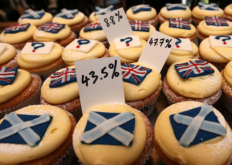 
              A view of cupcakes decorated with the Union and Scottish Saltire flags, and question marks, along with the results of sales, at Cuckoo's bakery, in Edinburgh, Scotland, Wednesday, Sept. 17, 2014. The bakery has been monitoring the sales of its Union and Saltire flag and undecided cupcakes for 200 days to try and predict the outcome of the referendum. 43.5 percent of sales were Yes cakes, 47.7 percent No, and 8.8 percent undecided.  (AP Photo/Scott Heppell)
            