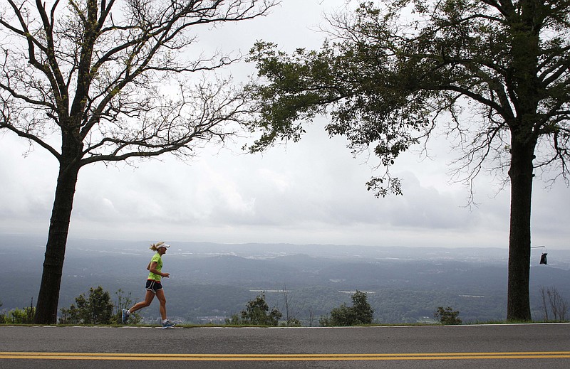 Signal Mountain resident Ann Farmer runs along North Palisades Drive overlooking the Tennessee Valley.