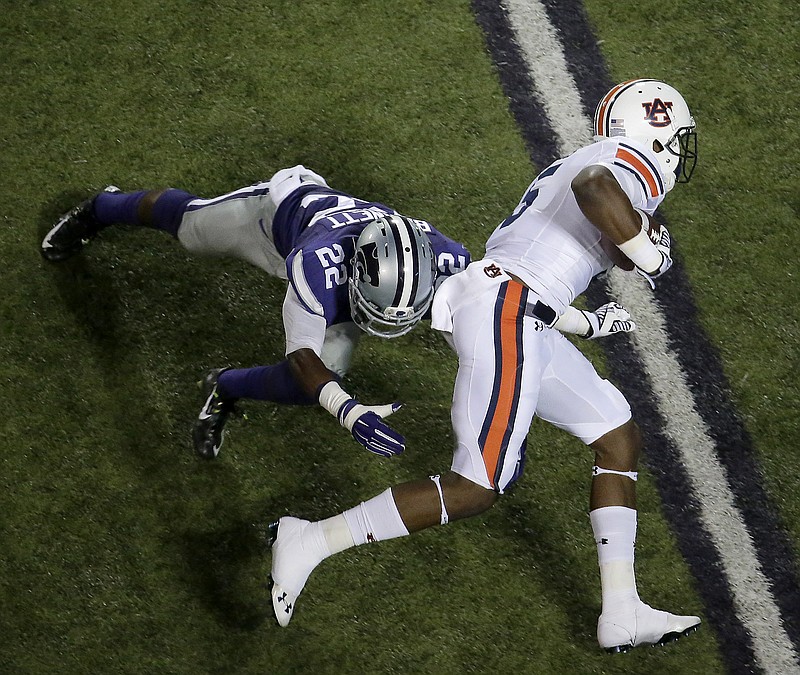 
              Auburn wide receiver Ricardo Louis (5) gets past Kansas State defensive back Dante Barnett (22) to score a touchdown during the first half of an NCAA college football game Thursday, Sept. 18, 2014, in Manhattan, Kan. (AP Photo/Charlie Riedel)
            