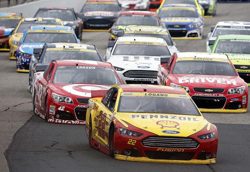 
              Joey Logano (22) takes the lead on the final restart during the NASCAR Sprint Cup series auto race at New Hampshire Motor Speedway on Sunday, Sept. 21, 2014, in Loudon, N.H. Logano went on to win the race. (AP Photo/Jim Cole)
            