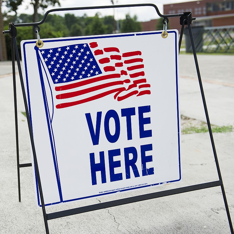 
              FILE - In this July 22, 2014 file photo, A "Vote Here" sign is seen outside the main entrance to the Fleming Park Bernie Ward Community Center during a run-off election day in Augusta, Georgia. (AP Photo/The Savannah Morning News, Sara Caldwell)
            