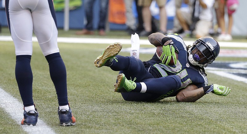 
              Seattle Seahawks running back Marshawn Lynch scores the game-winning touchdown in overtime of an NFL football game against the Denver Broncos, Sunday, Sept. 21, 2014, in Seattle. The Seahawks defeated the Broncos 26-20. (AP Photo/Elaine Thompson)
            