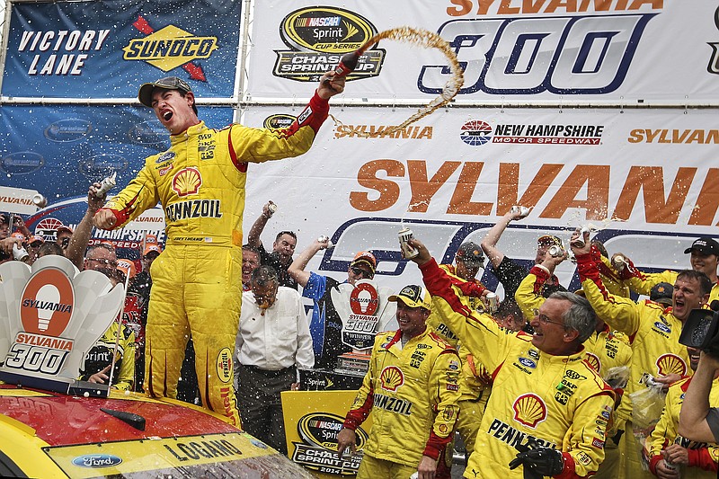 
              Joey Logano celebrates in Victory Lane after winning the NASCAR Sprint Cup series auto race at New Hampshire Motor Speedway, in Loudon, N.H., Sunday, Sept. 21, 2014. (AP Photo/Cheryl Senter)
            