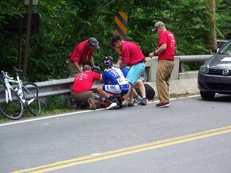 UnitedHealthcare professional cyclist Lucas Euser (21) and USA Cycling officials help BMC cyclist Taylor Phinney following Phinney's crash on Lookout Mountain in the 2014 USA Cycling Professional Road Championships on May 26. Euser abandoned the race to assist Phinney, who was severely injured in the accident. For his selfless actions, the United States Olympic Committee will award Euser the Jack Kelly Fair Play on Friday at the U.S. Olympic and Paralympic Assembly in Chicago.