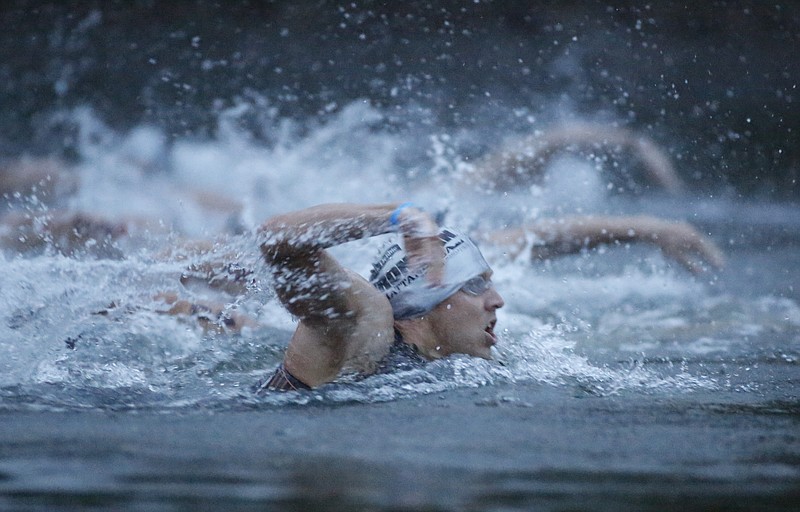 Ironman pro competitor Karol Kristov starts the swim section in the Tennessee River with other pro athletes to begin the Ironman Triathlon.