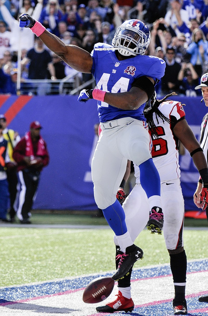 
              New York Giants running back Andre Williams (44) celebrates after scoring on a touchdown run against the Atlanta Falcons during the second half of an NFL football game, Sunday, Oct. 5, 2014, in East Rutherford, N.J. (AP Photo/Bill Kostroun)
            