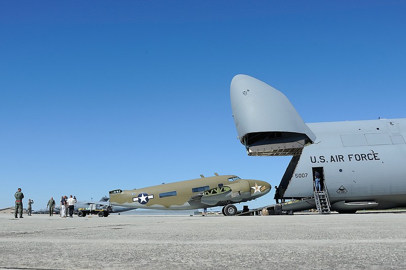
              In the photo taken Oct. 5, 2014, provided by the US Air Force, a Lockheed C-60 LoadStar, left, is positioned at the base of the lowered ramp of a Lockheed C-5M Super Galaxy of the 436th Airlif, for loading, at Warner-Robins Air Force Base, Ga. The Air Mobility Command Museum is now the only place in the United States where one can see a complete set of every significant Lockheed airlifter built since World War II. The museum at Dover Air Force Base completed its collection Tuesday when it received a C-60 Lodestar airlifter. (AP Photo/Greg L. Davis, US Air Force) A Lockheed C-60 LoadStar (left) is positioned at the base of the lowered ramp of a Lockheed C-5M Super Galaxy of the 436th Airlift Wing Oct. 5, 2014, at Warner-Robins Air Force Base, Ga. The Super Galaxy is the only U.S. Air Force transport aircraft capable of transporting the Lockheed C-60 LoadStar fuselage as shown. The aircraft was retrieved for eventual display at the Air Mobility Command Museum at Dover AFB, Del. (U.S. Air Force photo/Greg L. Davis)
            