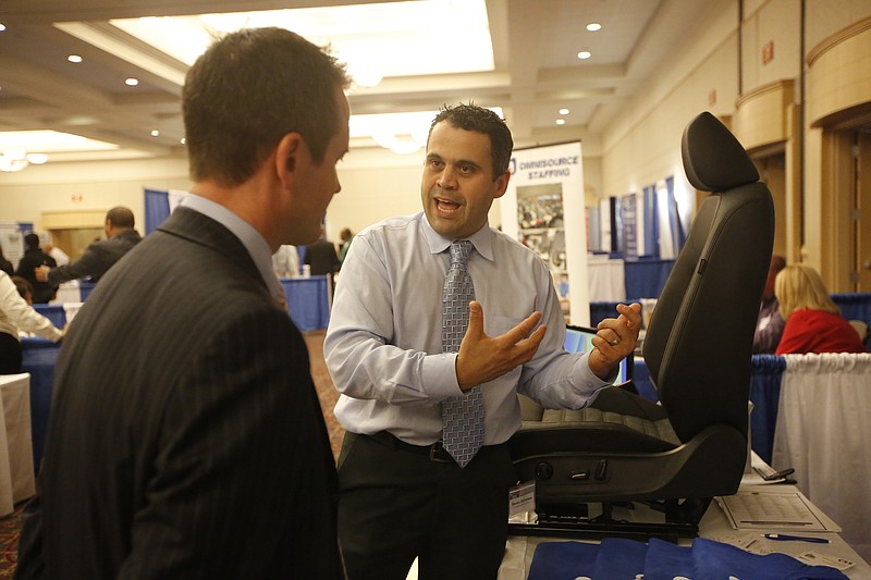 Steven Salvatore, right, with Chattanooga Seating Systems, talks with Ian Davies with Volkswagen on Friday, Oct. 17, 2014, at a Volkswagen minority purchasing and trade show at the Chattanooga Convention Center in Chattanooga.