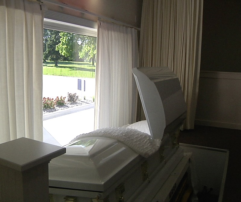 
              In this photo taken on Oct. 9, 2014, an empty casket on the other side of the “Drive-thru Viewing” window sits inside a room at Paradise Funeral Chapel in Saginaw, Mich. The funeral home recently started offering the option, which allows mourners to pay their last respects on the go. (AP Photo/Mike Householder)
            