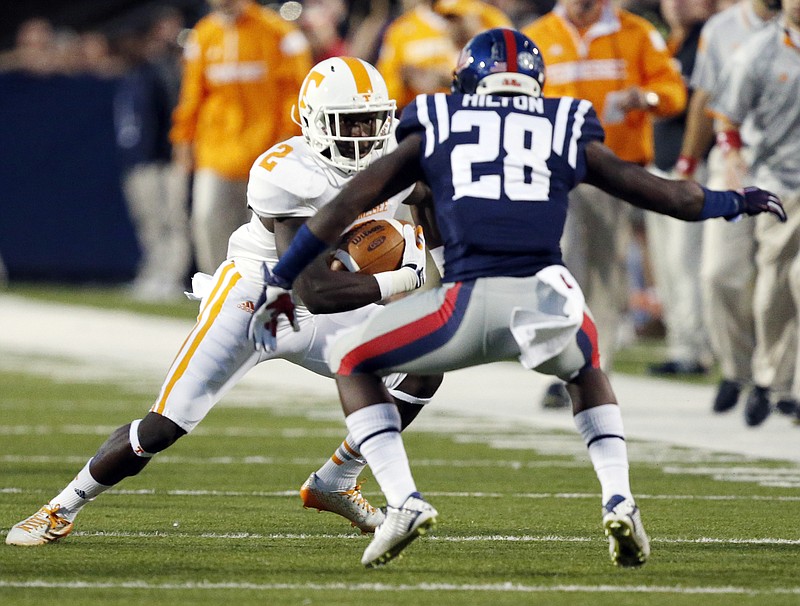 Tennessee wide receiver Pig Howard (2) attempts to run past Mississippi defensive back Mike Hilton (28) after a short pass reception in the first half of an NCAA college football game in Oxford, Miss., Saturday, Oct. 18, 2014.