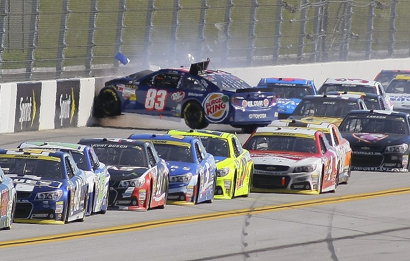 
              J.J. Yeley (83) wrecks on the backstretch during the NASCAR Sprint Cup Series auto race at Talladega Superspeedway, Sunday, Oct. 19, 2014, in Talladega, Ala. (AP Photo/Greg McWilliams)
            