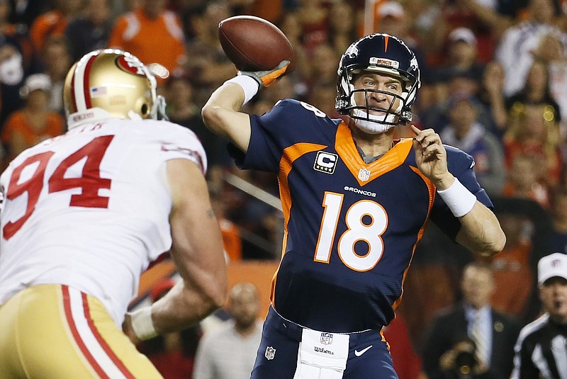 Denver Broncos quarterback Peyton Manning (18) throws a pass