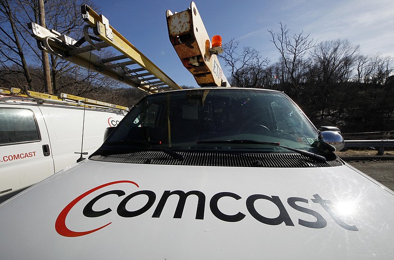 
              FILE - This Feb. 15, 2011 file photo, shows a Comcast logo on a Comcast installation truck in Pittsburgh. Comcast reports quarterly financial results on Thursday, Oct. 23, 2014. (AP Photo/Gene J. Puskar, File)
            