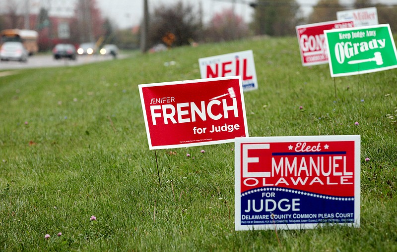 
              This Oct. 21, 2014 photo shows political campaign signs near a state highway in Westerville, Ohio. Signs touting local and statewide candidates are in full bloom along highways, street corners and public rights of way. Enter the Columbus Sign Ninjas, a group that sprang up to take down campaign clutter from public spaces. (AP Photo/Columbus Dispatch, Fred Squillante)
            