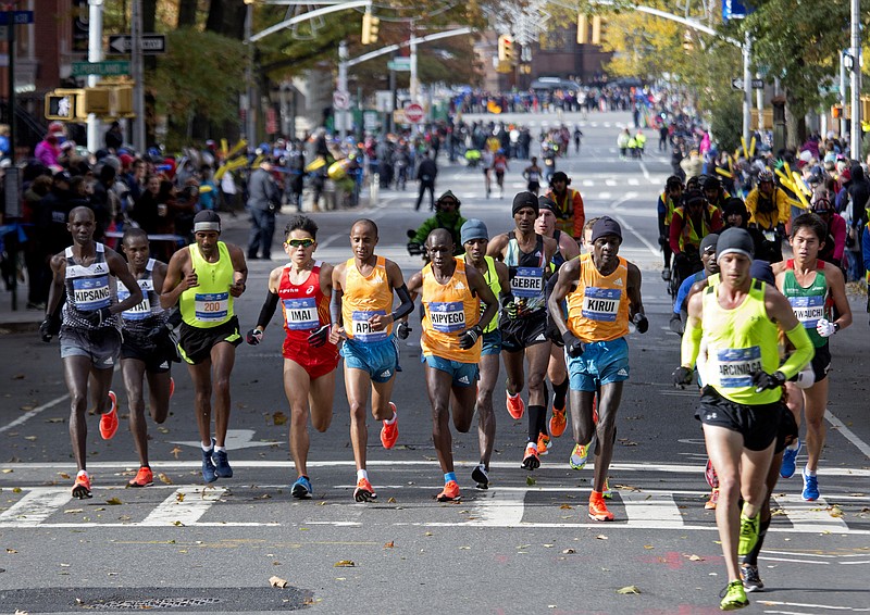 
              Runners in the men's division move through the borough of Brooklyn during the New York City Marathon in New York Sunday, Nov. 2, 2014. (AP Photo/Craig Ruttle)
            