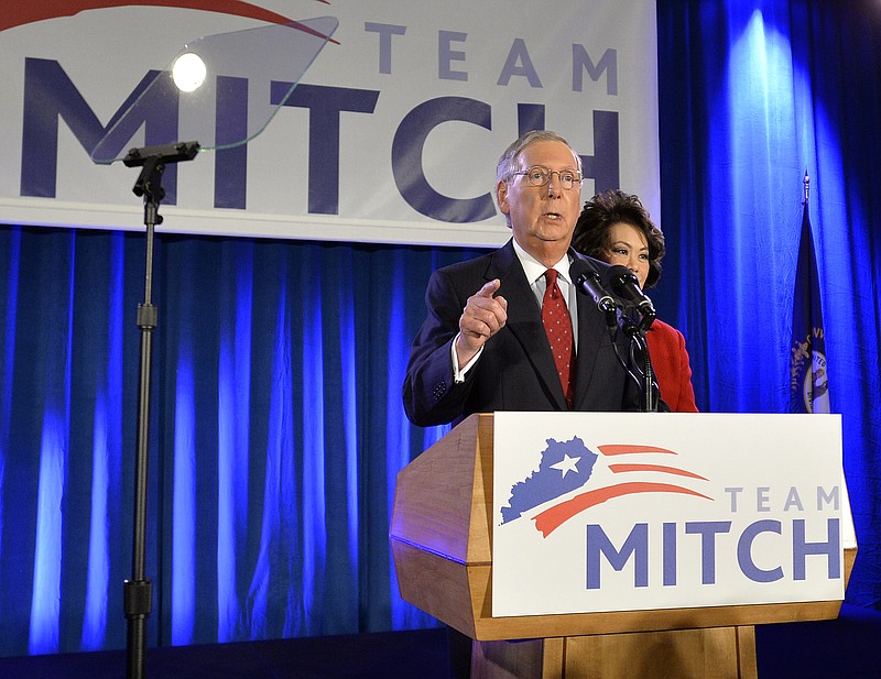 
              Senate Minority Leader Mitch McConnell of Ky., accompanied by is his wife, former Secretary of Labor Elaine Chao, addresses supporters at his victory celebration in Louisville, Ky., Tuesday, Nov. 4, 2014.  (AP Photo/Timothy D. Easley)
            