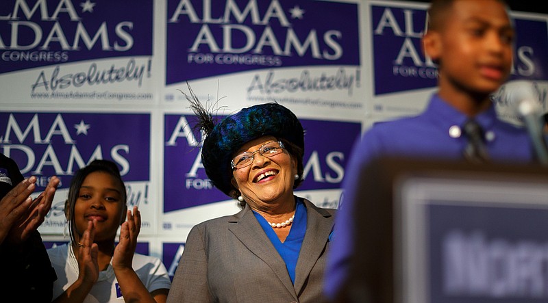 
              Democrat Alma Adams smiles as her grandson lauds her before she gives her victory speech after winning North Carolina's 12th Congressional District at the Greensboro Coliseum in Greensboro, N.C., on Tuesday, Nov. 4, 2014. (AP Photo/News & Record, Jerry Wolford)
            