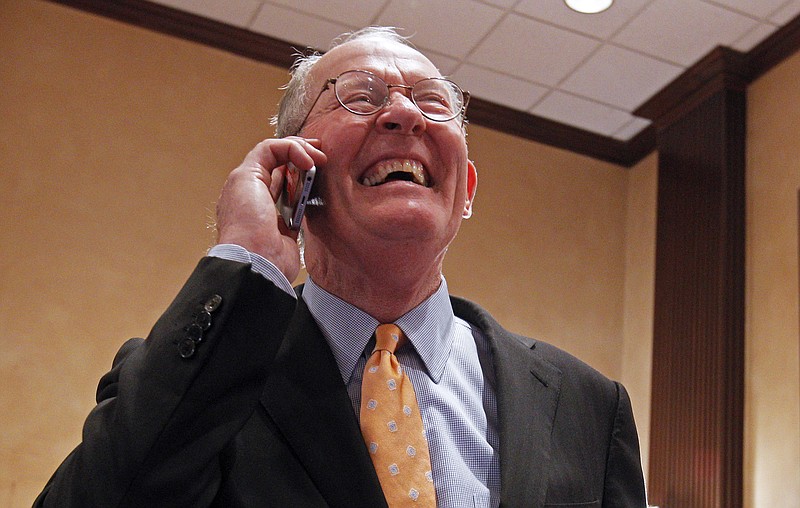 
              U.S. Sen. Lamar Alexander, R-Tenn. smiles as he talks on the phone after retaining his seat in the Senate, Tuesday, Nov. 4, 2014, in Knoxville, Tenn. (AP Photo/Wade Payne)
            