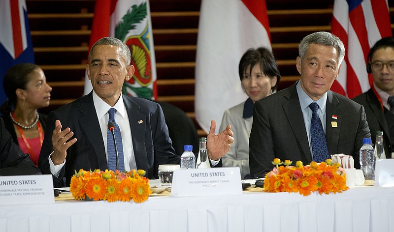U.S. President Barack Obama, left, speaks as he is seated with Singapore's Prime Minister Lee Hsien Loong, right, during a meeting with leaders of the Trans-Pacific Partnership countries on the sidelines of the APEC summit, Monday, Nov. 10, 2014, in Beijing. (AP Photo/Pablo Martinez Monsivais)
            