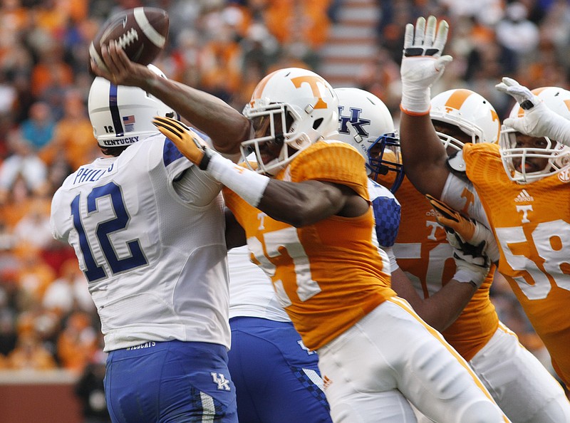 Tennessee's Justin Coleman (27) forces Kentucky quarterback Reese Phillips to fumble, turning the ball over for a Big Orange touchdown during their game at Neyland Stadium on Saturday, Nov. 15, 2014.