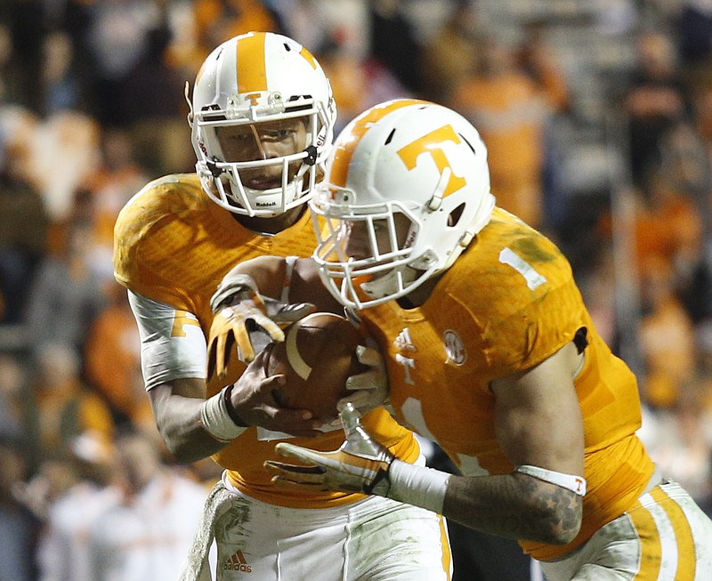 Tennessee quarterback Joshua Dobbs hands off the ball to running back Jalen Hurd during the Vols' 29-21 loss to the Missouri Tigers on Nov. 22, 2014, at Neyland Stadium in Knoxville.
