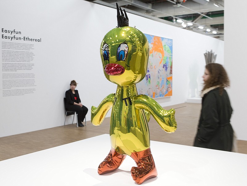 
              Visitors walk past "Titi 2004-2009 " by artist Jeff Koons of the United States, during a retrospective exhibition in the Centre Pompidou modern art museum in Paris, France, Tuesday Nov. 25, 2014. Paris’ Pompidou Center inaugurated Tuesday the first ever European retrospective on artist Jeff Koons, the polemical 59-year-old master of kitch, whose huge shiny, stainless-steel balloon dog broke records last year, selling at auction for $58.4 million. (AP Photo/Jacques Brinon)
            