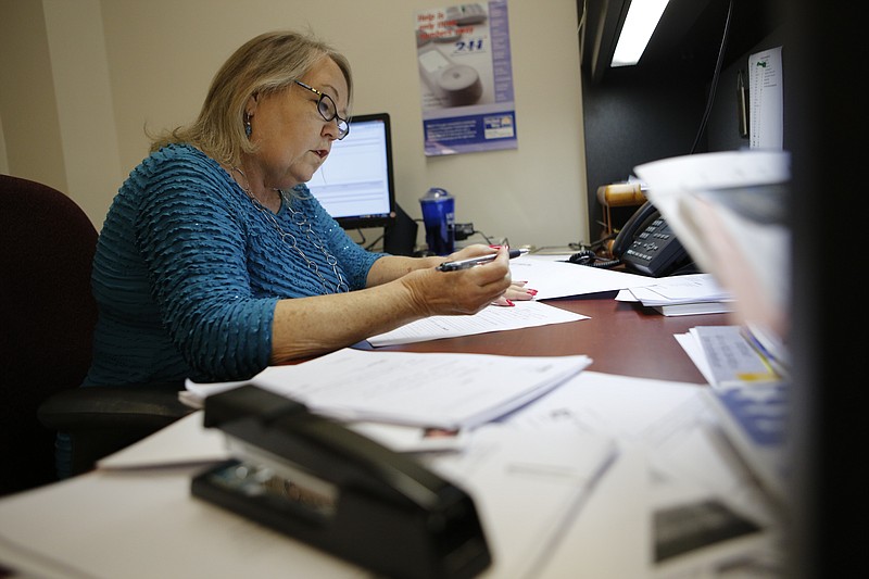 Diane Jarvis works at her desk on Neediest Cases on Tuesday in Chattanooga.