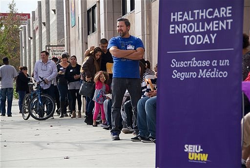 This photo provided by the Service Employees International Union shows people waiting to enter an Affordable Care Act enrollment event sponsored by SEIU-United Healthcare Workers West and Community Coalition, in Los Angeles on Nov. 15, 2014.