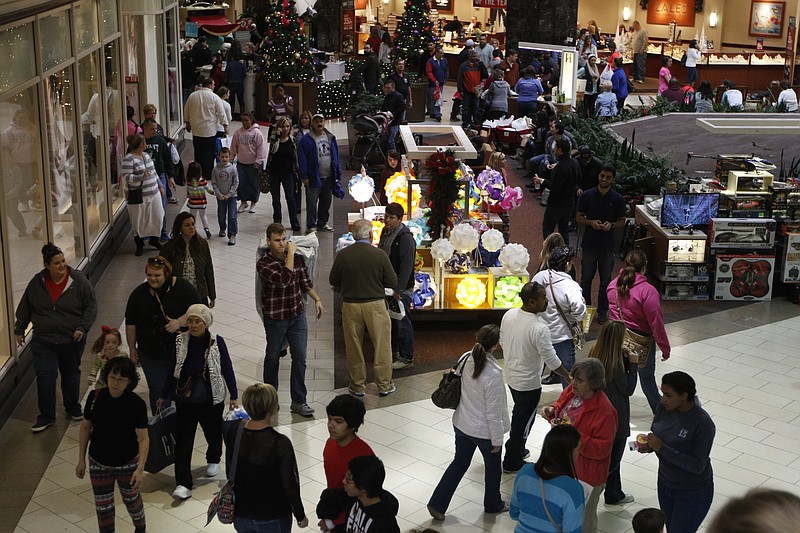 People walk between stores at Hamilton Place Mall.
