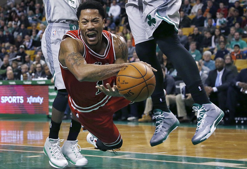 
              Chicago Bulls guard Derrick Rose falls after being tripped while driving against the Boston Celtics in the first half of an NBA basketball game in Boston, Friday, Nov. 28, 2014. (AP Photo/Elise Amendola)
            