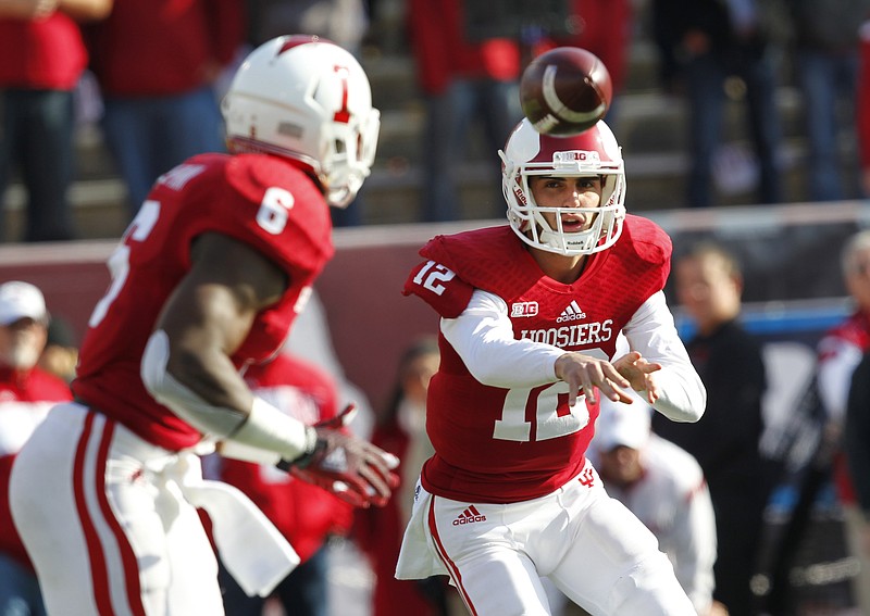 
              Indiana quarterback Zander Diamont (12) pitches the football to Tevin Coleman (6) during the first half of an NCAA college football game against Purdue, in Bloomington, Ind., Saturday Nov. 29, 2014. (AP Photo/John Sommers II)
            