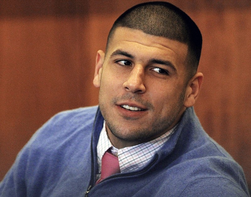 
              FILE - In this Oct. 1, 2014 file photo, former New England Patriots football player Aaron Hernandez looks back during an evidentiary hearing at Fall River Superior Court in Fall River, Mass.  Authorities have returned to the home of ex-New England Patriots player Aaron Hernandez seeking sneakers they believe were worn on the night of a 2013 killing he's charged in. The Sun Chronicle reports state and local authorities went to Hernandez's North Attleborough home this week but seized no evidence. (AP Photo/The Boston Globe, Wendy Maeda, Pool)
            