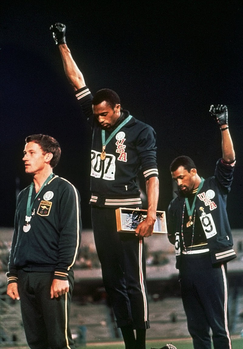 
              FILE - In this Oct. 16, 1968, file photo, U.S. athletes Tommie Smith, center, and John Carlos stare downward while gesturing skyward during the playing of the Star Spangled Banner after Smith received the gold and Carlos the bronze for the 200 meter run at the Summer Olympic Games in Mexico City. Australian silver medalist Peter Norman is at left. Time will tell whether the ``hands-up'' gesture that five St. Louis Rams made during pregame introductions on Sunday, Nov. 30, 2014, will leave a lasting memory or simply go down as a come-and-go moment in the age of the 24-hour news cycle. Either way, it certainly isn't the first time high-profile athletes have used their platform to make political statements. (AP Photo/File)
            