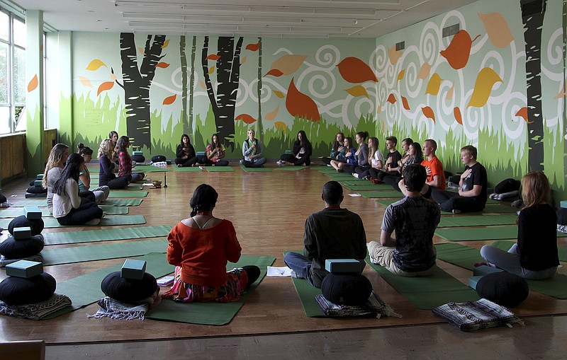 
              In this Oct. 1, 2014 photo, students meditate during Mindful Studies class at Wilson High School in Portland, Ore. The year-long course is one of a growing number of programs that are incorporating mindfulness, yoga and meditation into school curriculums to bring socio-emotional benefits to students. (AP Photo/Gosia Wozniacka)
            