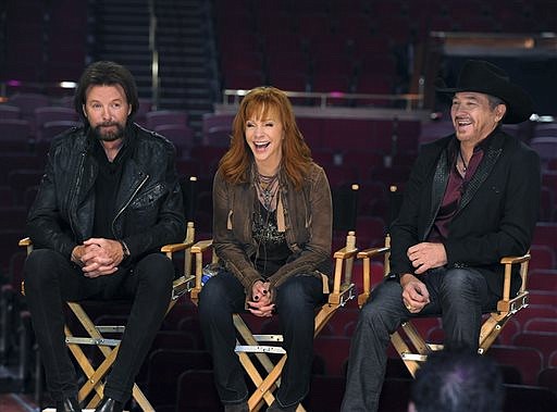 Reba McEntire, center, laughs with Ronnie Dunn, left, and Kix Brooks, of the duo Brooks & Dunn, during a news conference on, Dec. 3, 2014, in the Colosseum at Caesars Palace in Las Vegas.