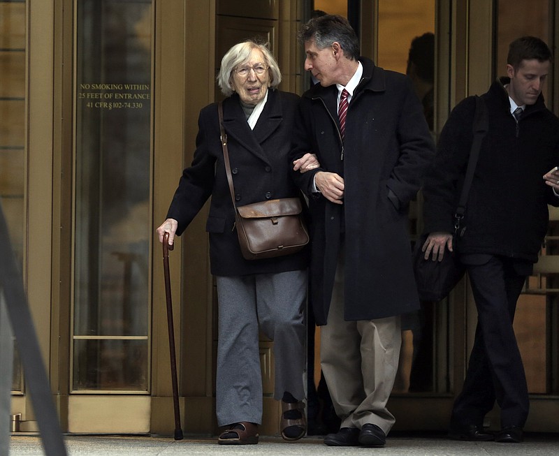 
              Miriam Moskowitz, 98, accompanied by her nephew Ira Moskowitz, leaves federal court in New York on Thursday, Dec. 4, 2014 after a judge rejected her request to erase her 1950 conviction for conspiracy to obstruct justice in the run-up to the atomic spying trial of Julius and Ethel Rosenberg. She served a two-year prison sentence. (AP Photo/Richard Drew)
            