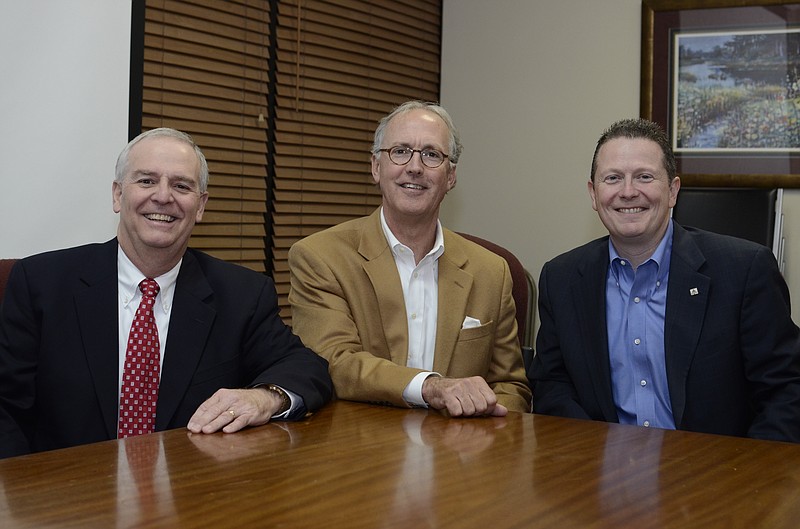 Cornerstone Community Bank President Barry Watson, Cornerstone Chairman Miller Welborn and SmartBank President and CEO Billy Carroll discuss the specifics of a partnership between SmartFinancial and Cornerstone Bancshares at a processing center for Cornerstone Bank in Chattanooga, Tenn.