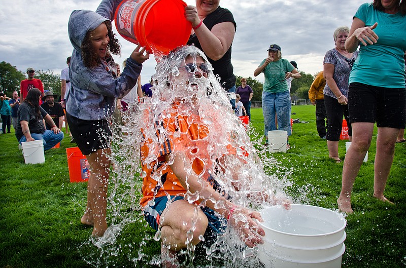 
              FILE - In this Saturday, Sept. 27, 2014, file photo, Chas McKhann has ice water poured on himself during the Walla Walla Grand Ice Bucket Challenge in Walla Walla, Wash. From June 1 to Sept. 1, 2014, Facebook users shared more than 17 million videos related to the Ice Bucket Challenge, a campaign designed to raise awareness and money for amyotrophic lateral sclerosis, better known as Lou Gehrig’s Disease. (AP Photo/Walla Walla Union-Bulletin, Greg Lehman, File)
            