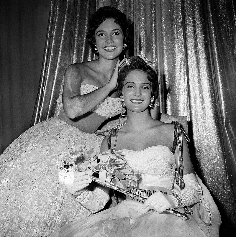 
              FILE - In this Sept. 12, 1959 file photo, Miss America of 1960, Miss Mississippi, Lynda Lee Mead, right, of Natchez, is crowned by outgoing Miss America, Mary Ann Mobley, top left, also of Mississippi, in Atlantic City, N.J.  The former Miss America, Mobley, who went on to appear in movies with Elvis Presley and make documentary films around the world has died. A spokesman for the University of Mississippi confirmed that Mary Ann Mobley Collins died Tuesday, Dec. 9, 2014, in Beverly Hills, Calif. She was 75. (AP Photo/Bill Achatz, File)
            