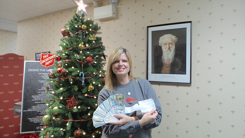 Salvation Army Director of Volunteer Services Stacey Crisp shows the donation.