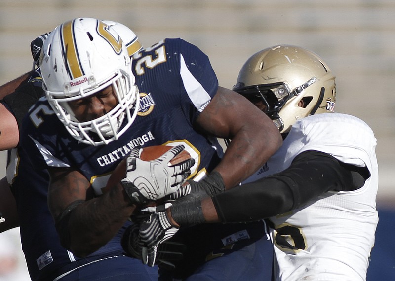 UTC running back Keon Williams pushes through Wofford linebacker Terrance Morris during the Mocs' 31-13 win over the Wofford Terriers on Nov. 8. The win netted the Mocs the SoCon championship and a spot in the playoffs.