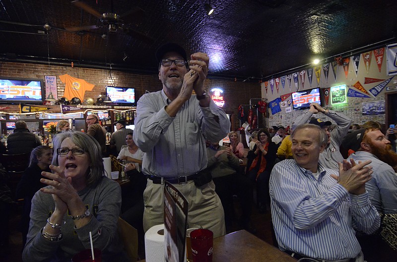 UTC fans Charlotte and Lucien Ellington, and Bill Bratton, from left, cheer for the Mocs at Jefferson's on Georgia Avenue during the playoff against New Hampshire.