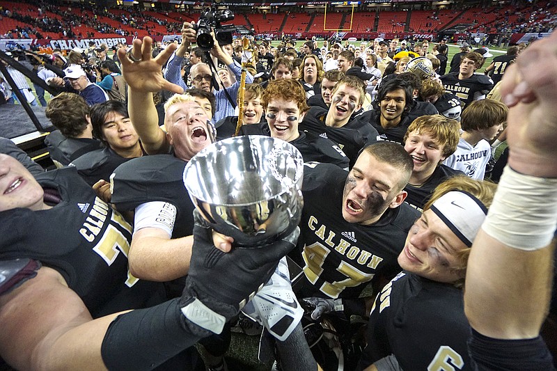 Calhoun High School players celebrate their win over Washington County during the GHSA class AAA championship game at the Georgia Dome in Atlanta, Ga. on Friday.  The Yellowjackets won the state championship over the the Golden Hawks with a final score of 27-20. 