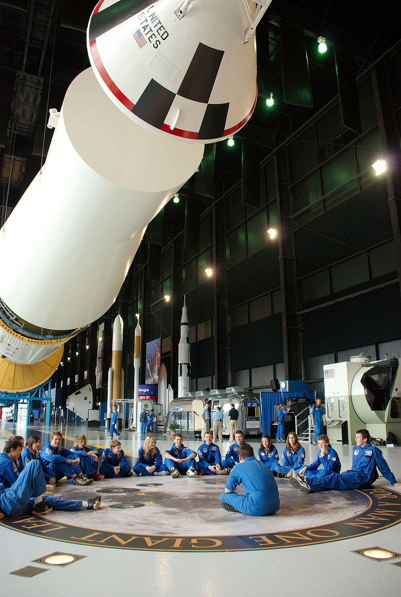 Members of Space Camp sit beneath a Saturn V rocket in the Davidson Center for Space Exploration at the U.S. Space and Rocket Center in this file photo.