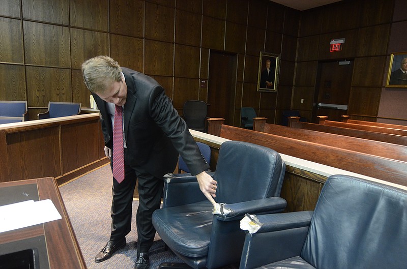 Criminal Court Judge Barry Steelman points out the poor condition of chairs in his courtroom in the Hamilton County/Chattanooga City Courts building in this file photo.